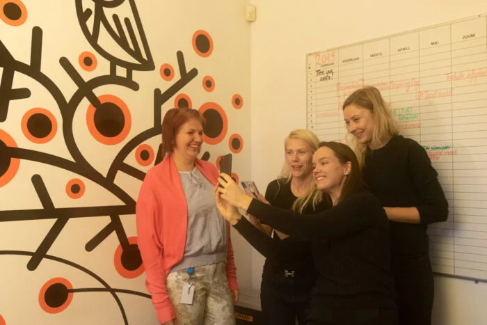 A team of colleagues playing an office scavenger hunt game for team building purposes
