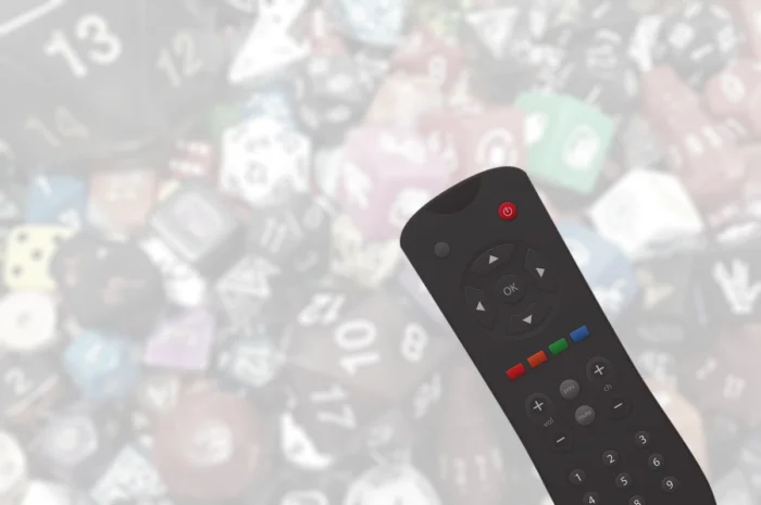 Picture of a remote control on top of many dices